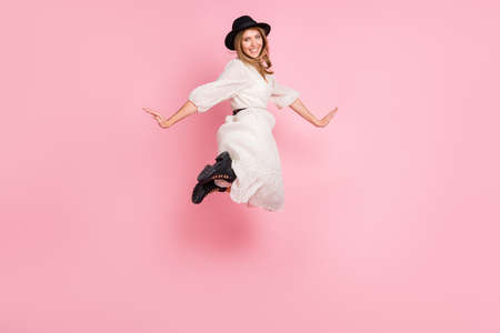 Full length photo of funny lady jump toothy smile wear vintage headwear dotted dress boots isolated...