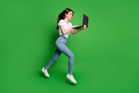 Full body profile side photo girl jump run search discount laptop wear t-shirt jeans isolated green...