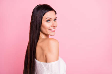 Photo of young attractive pretty happy smiling flirty girl with naked shoulder look camera isolated on pink color backgroundの写真素材