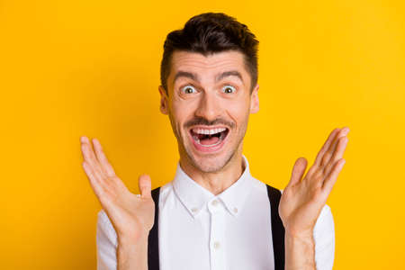 Photo portrait of amazed shocked cheerful happy guy shouting staring happy isolated on vivid yellow...