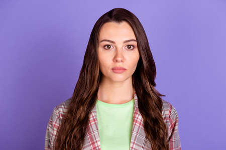 Photo of serious young lady serious face mood wear checkered shirt isolated on purple color...
