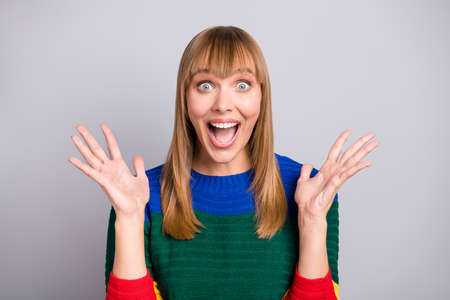 Photo portrait of amazed shocked blonde woman staring gesturing with hands isolated on pastel grey...