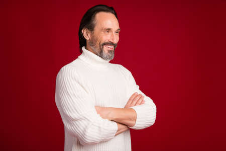 Profile photo of positive guy folded hands beaming smile look empty space wear sweater isolated on...