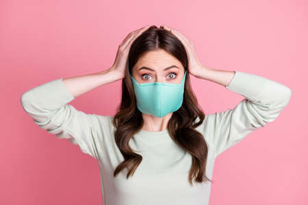 Portrait of curly hairstyle lady hold arms on head wear medical cold safety respiratory isolated on...