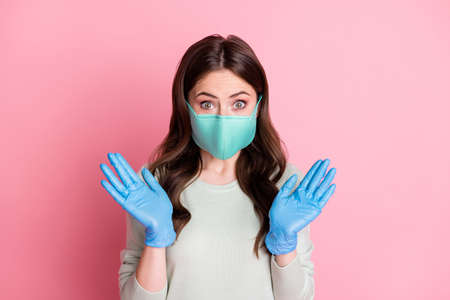 Portrait of curly hairstyle lady showing arms gloves wear cold safety medical mask isolated on pink...