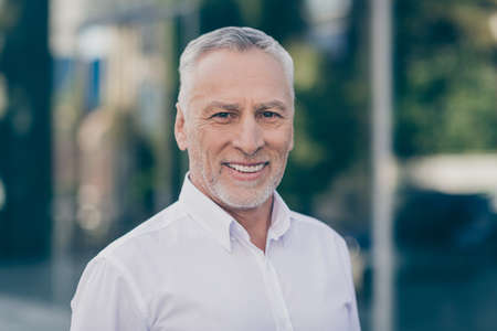 Photo of optimistic grey hair old business man wear white shirt outdoors near work center
