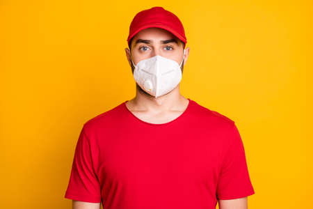 Close-up portrait of healthy guy wearing n95 respirator mers cov prevention stop pandemia concept isolated on bright yellow color backgroundの写真素材