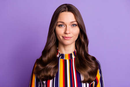 Photo portrait of smiling woman wearing striped shirt isolated on bright purple color background