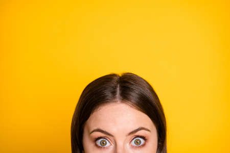 Cropped photo of astonished girl impressed advertising copyspace isolated over yellow color backgroundの写真素材
