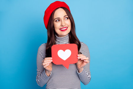 Photo portrait of woman curious dreamy in beret showing like icon social media looking copyspace isolated vibrant blue color backgroundの写真素材
