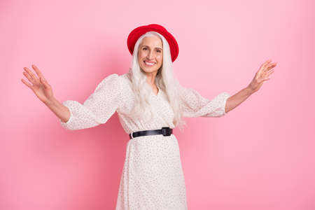 Portrait of charming cheerful grey-haired granny dancing festal event occasion isolated over pink...
