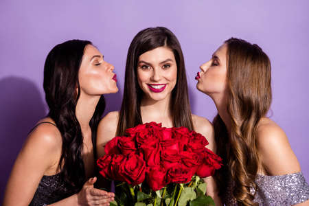 Photo of three coquette ladies hold roses send air kiss wear fancy dresses isolated purple color backgroundの写真素材