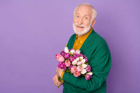 Profile photo of positive person hands hold flowers toothy smile look camera isolated on violet...