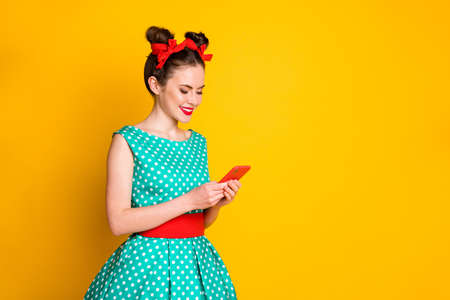 Turned photo of positive girl use smartphone follow post wear turquoise clothes isolated shine color backgroundの写真素材