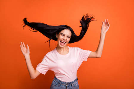 Photo of impressed brunette lady arms up yell wear pink t-shirt isolated on bright orange color backgroundの写真素材