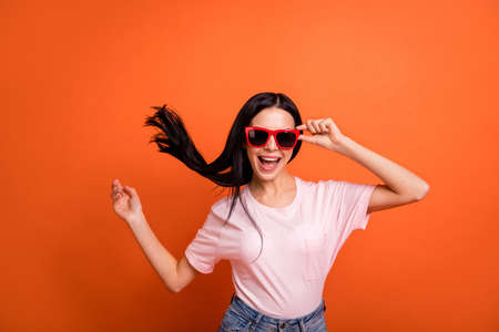 Photo of impressed brunette lady wear spectacles pink t-shirt isolated on bright orange color backgroundの写真素材