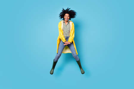 Full length portrait of carefree cheerful dark skin person good mood toothy smile isolated on blue color backgroundの写真素材