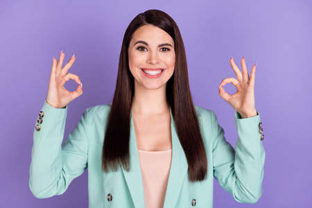 Photo of young lovely pretty smiling cheerful businesswoman showing okay sign isolated on violet...