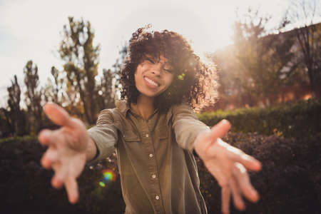 Portrait of lovely curly hairstyle dark skin lady raise hands you toothy smile nice sunny autumn...