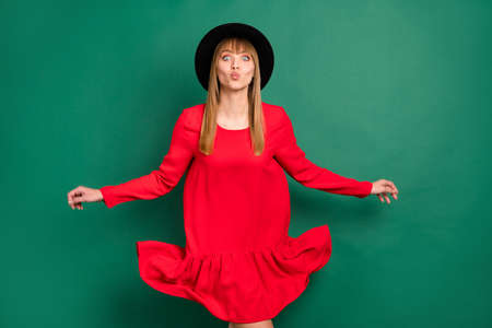 Photo of young charming attractive lovely pretty funny girl in red dress send air kiss isolated on...