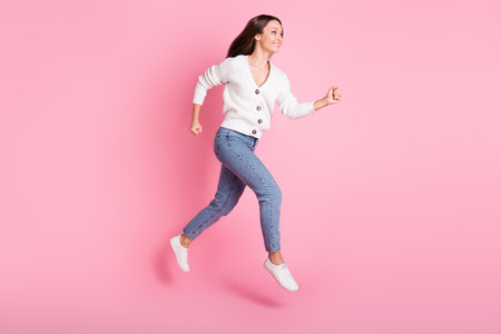 Full size profile side photo of cheerful happy young lady jump up run empty space sale isolated on...