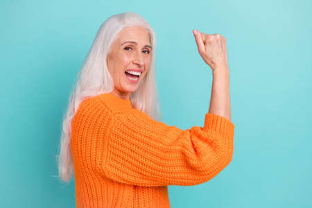 Profile side view portrait of attractive cheerful lucky grey-haired woman rejoicing success isolated...