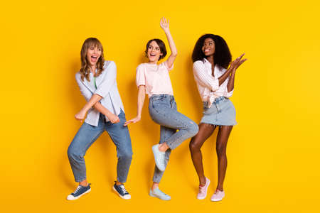 Full size photo of pretty cheerful persons diversity enjoy free time chilling isolated on yellow color backgroundの写真素材