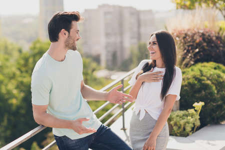 Photo of two funny people spend funny time enjoy together talk laugh wear casual clothes street outdoorsの写真素材