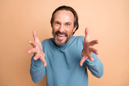 Photo portrait of angry man ready to choke you isolated on pastel beige colored background