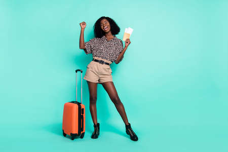 Photo of lady celebrate victory hold tickets document bag wear leopard print shirt isolated teal color backgroundの写真素材