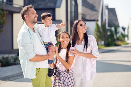 Photo of sweet funny family boy pointing walk near home wear casual cloth outsideの写真素材