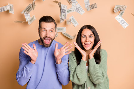 Photo of young crazy happy excited smiling cheerful positive couple win lot of money isolated on...