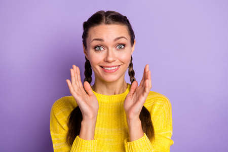 Portrait of impressed brunette girl wear yellow sweater isolated on pastel lilac color background