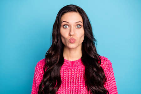 Portrait of attractive amorous wavy-haired girl sending air kiss 14 February isolated over vibrant...