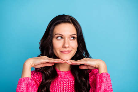 Photo of gorgeous lady arms under chin look interested empty space smile isolated on blue color backgroundの写真素材