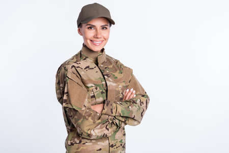 Profile side photo of young woman happy smile soldier army officer crossed hands uniform isolated over white color backgroundの写真素材
