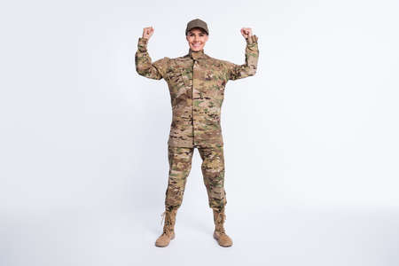 Full size photo of young woman soldier officer army show hand biceps power strong isolated over white color backgroundの写真素材