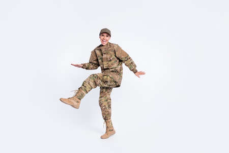 Full length portrait of cheerful carefree girl open mouth smile raise foot beaming smile isolated on white color backgroundの写真素材
