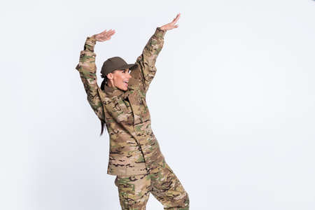 Portrait of crazy satisfied girl pointing arms look empty space have fun isolated on white color backgroundの写真素材
