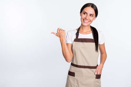 Portrait of pretty positive girl look direct thumb empty space put hand in pocket isolated on white...