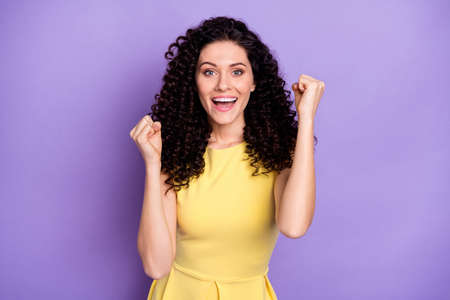 Photo of wavy hairdo astonished person fists up open mouth celebrate isolated on violet color backgroundの写真素材