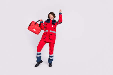 Full size photo of hooray nice brunette lady with bag hands fists wear uniform isolated on grey color backgroundの写真素材