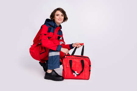 Full size profile photo of optimistic nice brunette lady open bag wear uniform isolated on grey color backgroundの写真素材