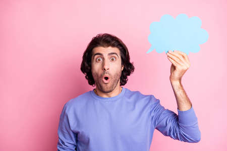 Portrait of impressed person hand hold cloud shape open mouth wear purple pullover isolated on pink color backgroundの写真素材