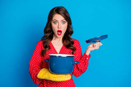 Photo of young attractive speechless surprised amazed shocked girl open pot isolated on blue color backgroundの写真素材