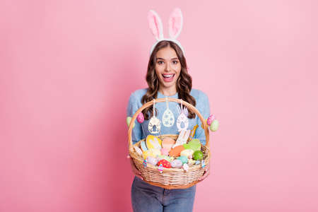 Photo of excited lady hold easter basket open mouth wear bunny ears headband blue pullover isolated...