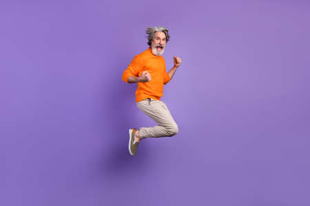 Full size profile side photo of mature man excited rejoice win victory jump up happy smile isolated...