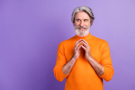 Photo of mature man happy positive smile cunning tricky idea plan look empty space isolated over purple color backgroundの写真素材