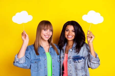 Portrait of attractive cheerful persons dark skin hold cloud figure empty space isolated on yellow color backgroundの写真素材