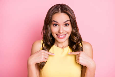 Photo of confused charming person direct fingers herself cant believe toothy smile isolated on pink color backgroundの写真素材